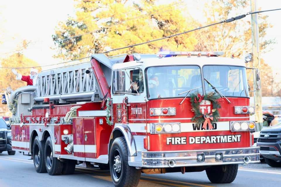 Santa is coming riding in the bucket of the Ward Fire Dept bucket truck